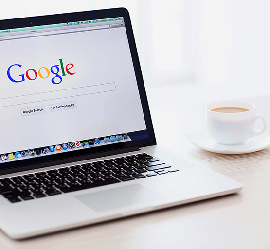 laptop opened to Google homepage